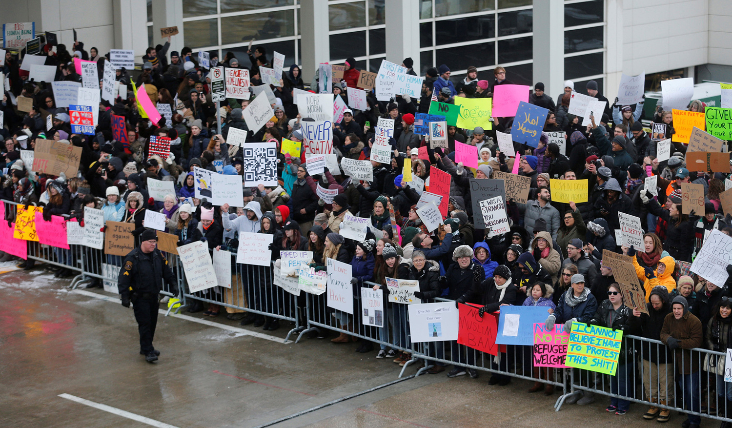 Hundreds of people rally against the temporary travel ban during a protest at Detroit Metropolitan airport in Romulus, Michigan, on January 29, 2017.